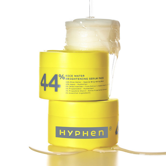 Yellow container of Hyphen 44% Rice Water Brightening Serum Pads on a white background